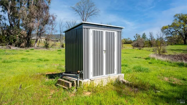 a backyard of a house with table and chairs