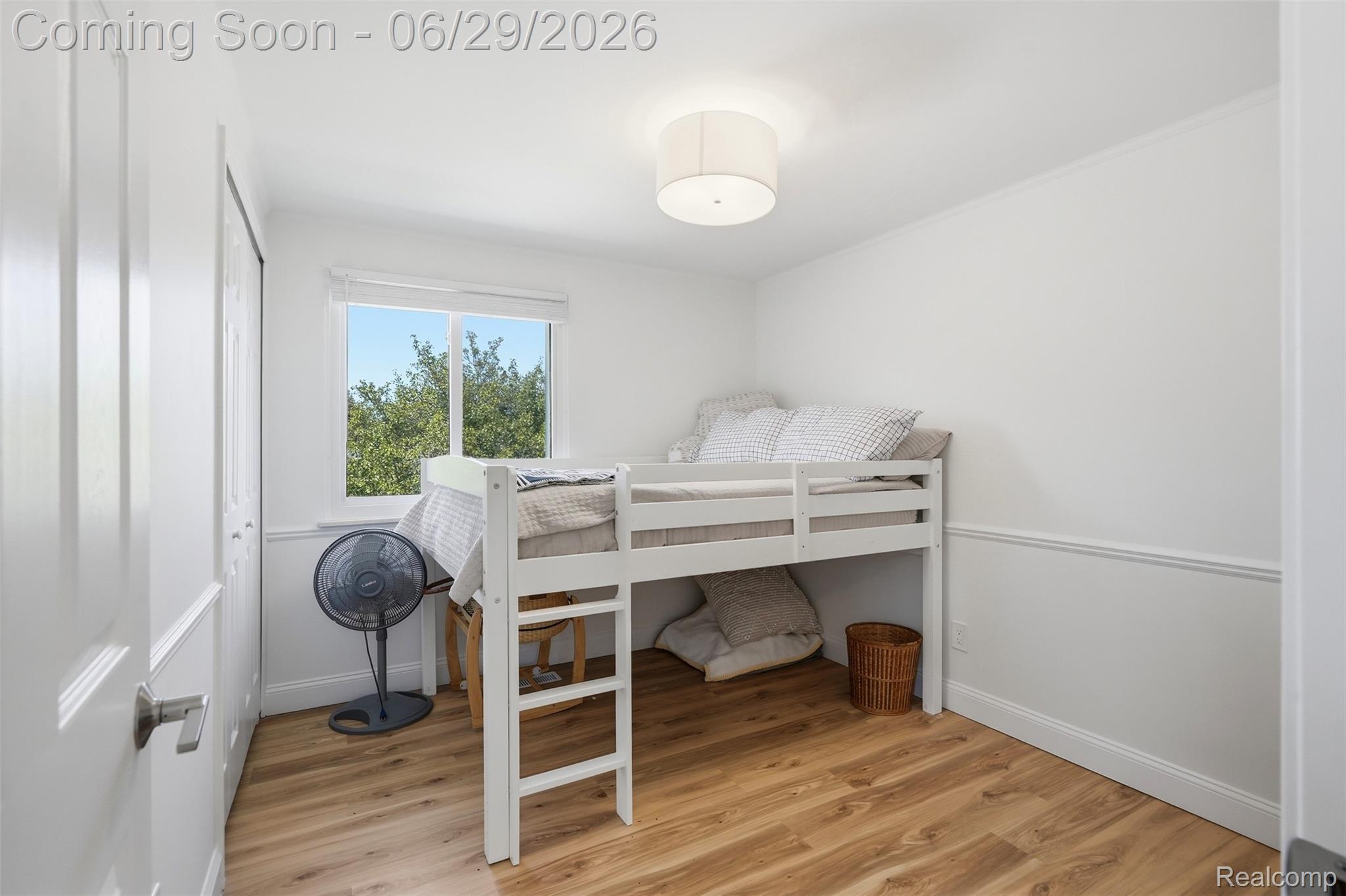 45179 Rudgate Road Canton, MI 48188 - Photo 20 of 48 Bedroom featuring wood-finish flooring, a window with natural light, white painted walls, white trim, and a semi-flush mount ceiling light