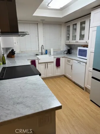 a kitchen with a stove a sink and a microwave