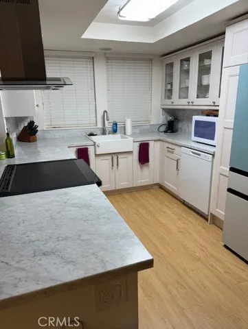 a kitchen with a stove a sink and a microwave