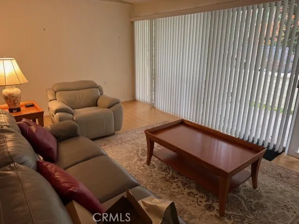 a bedroom with a bed window and chair