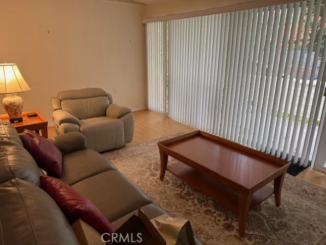 a bedroom with a bed window and chair