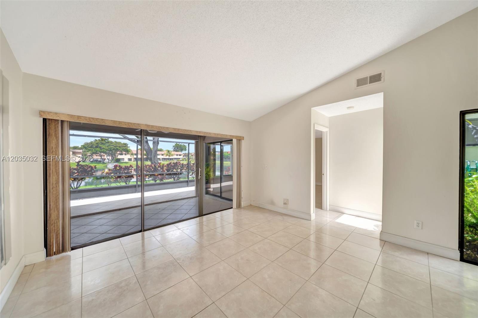 5223 Gate Lake Road, Unit 5223 Tamarac, FL 33319 - Photo 17 of 37 a view of an empty room with glass door