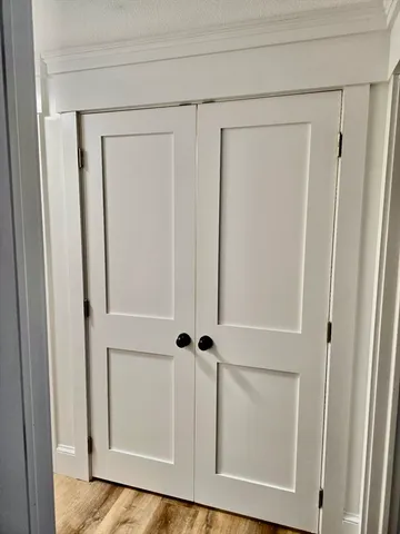 a view of a closet with wooden floor