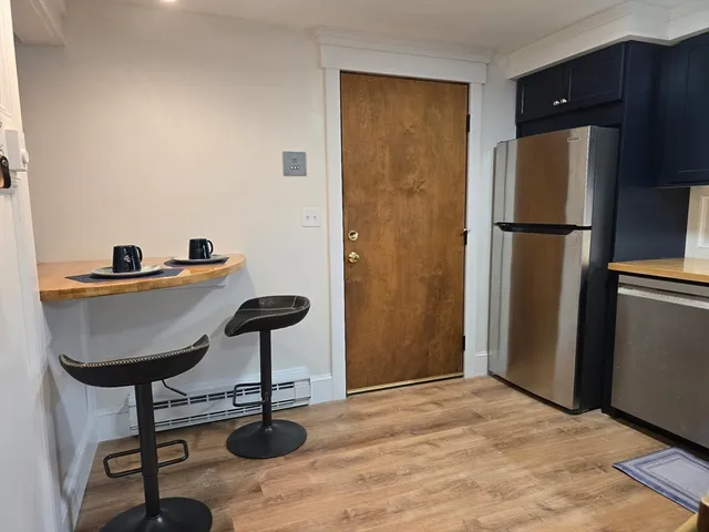 a kitchen with stainless steel appliances granite countertop a refrigerator and a sink