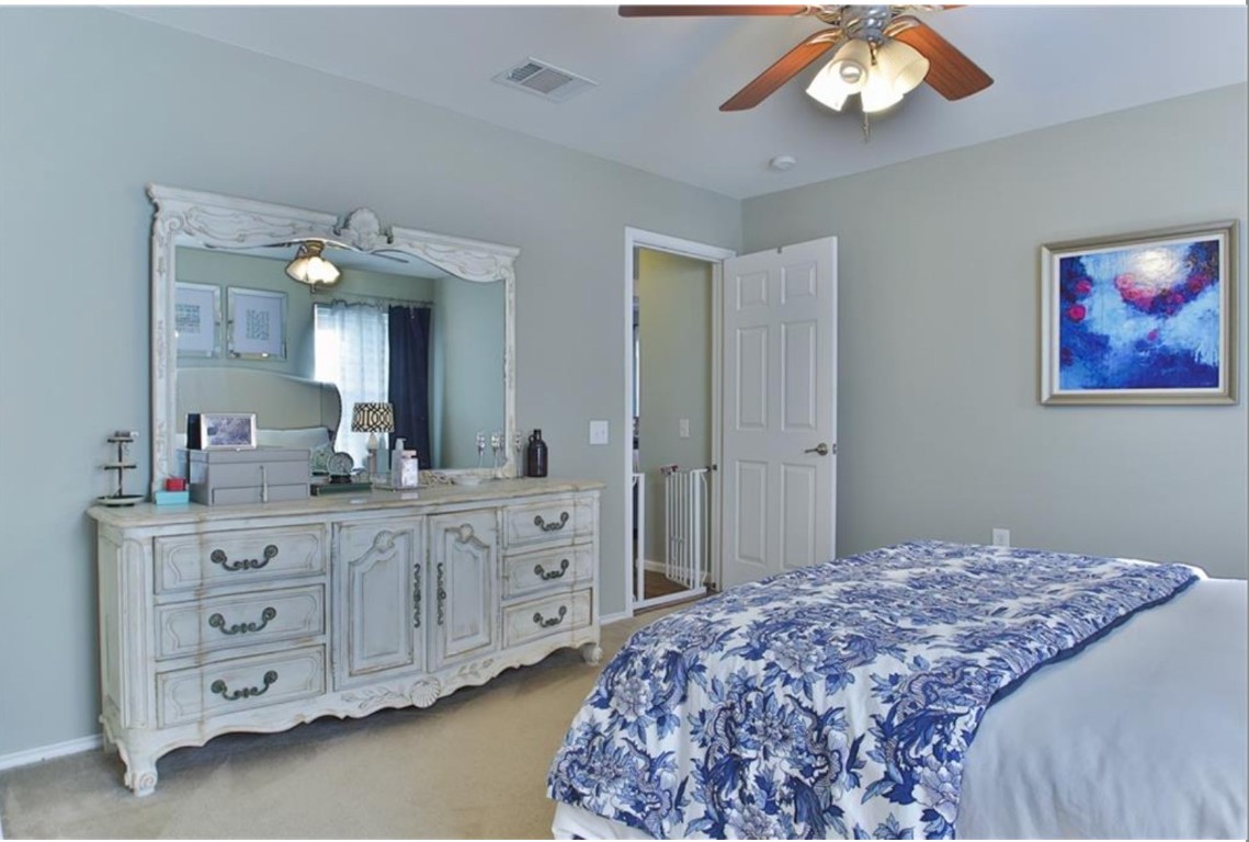 7637 Cayenne Lane Austin, TX 78741 - Photo 13 of 18 a bedroom with a bed and a chandelier