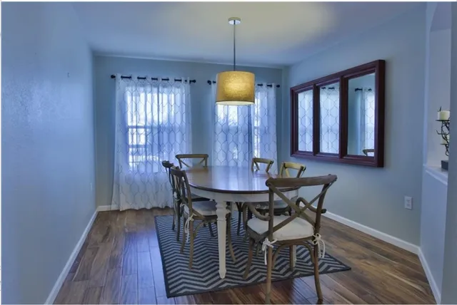 a view of a room with furniture and wooden floor