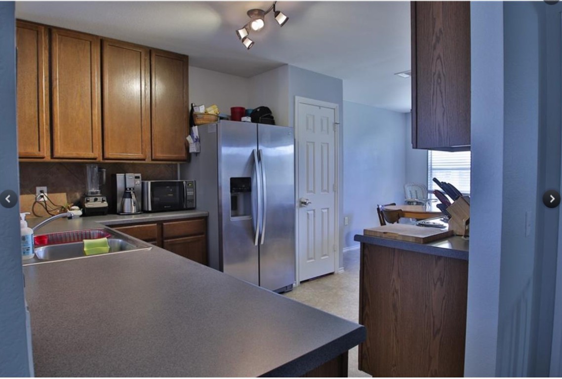 7637 Cayenne Lane Austin, TX 78741 - Photo 9 of 18 a kitchen with stainless steel appliances granite countertop a refrigerator and a sink