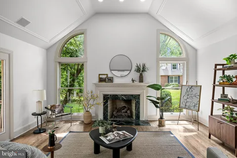 a living room with furniture a window and a fireplace
