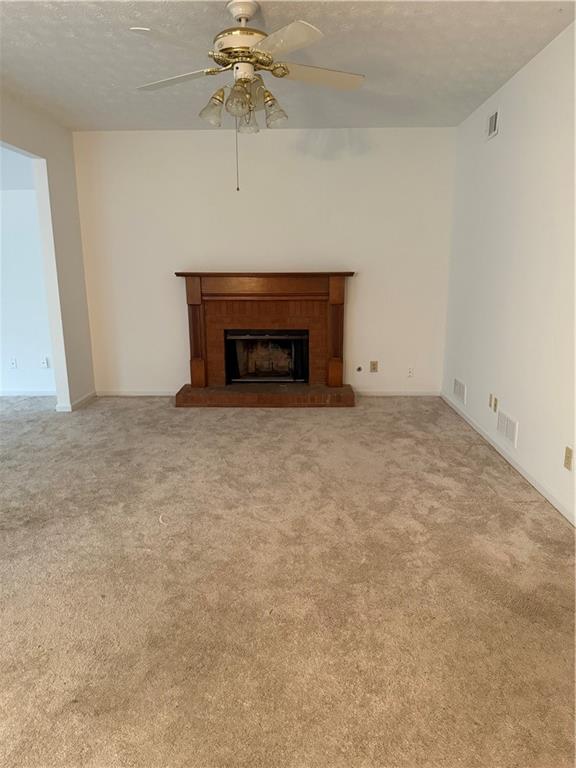 682 Bridge Way Lithonia, GA 30058 - Photo 9 of 25 an empty room with a fireplace