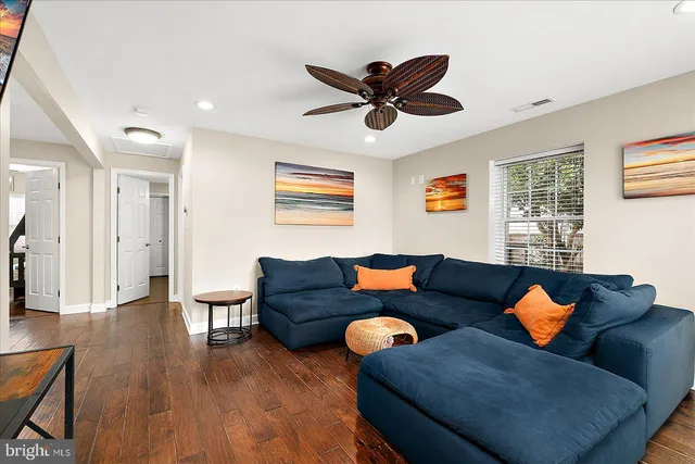 a dining room with furniture a rug and a mirror