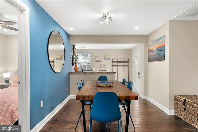 a kitchen with stainless steel appliances kitchen island granite countertop a refrigerator and cabinets
