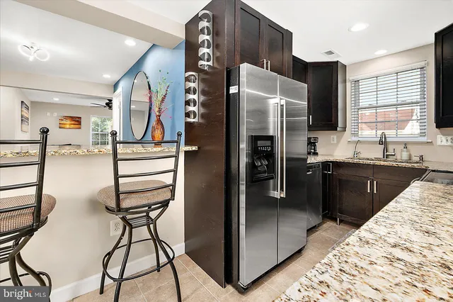 a kitchen with stainless steel appliances granite countertop a sink stove and microwave