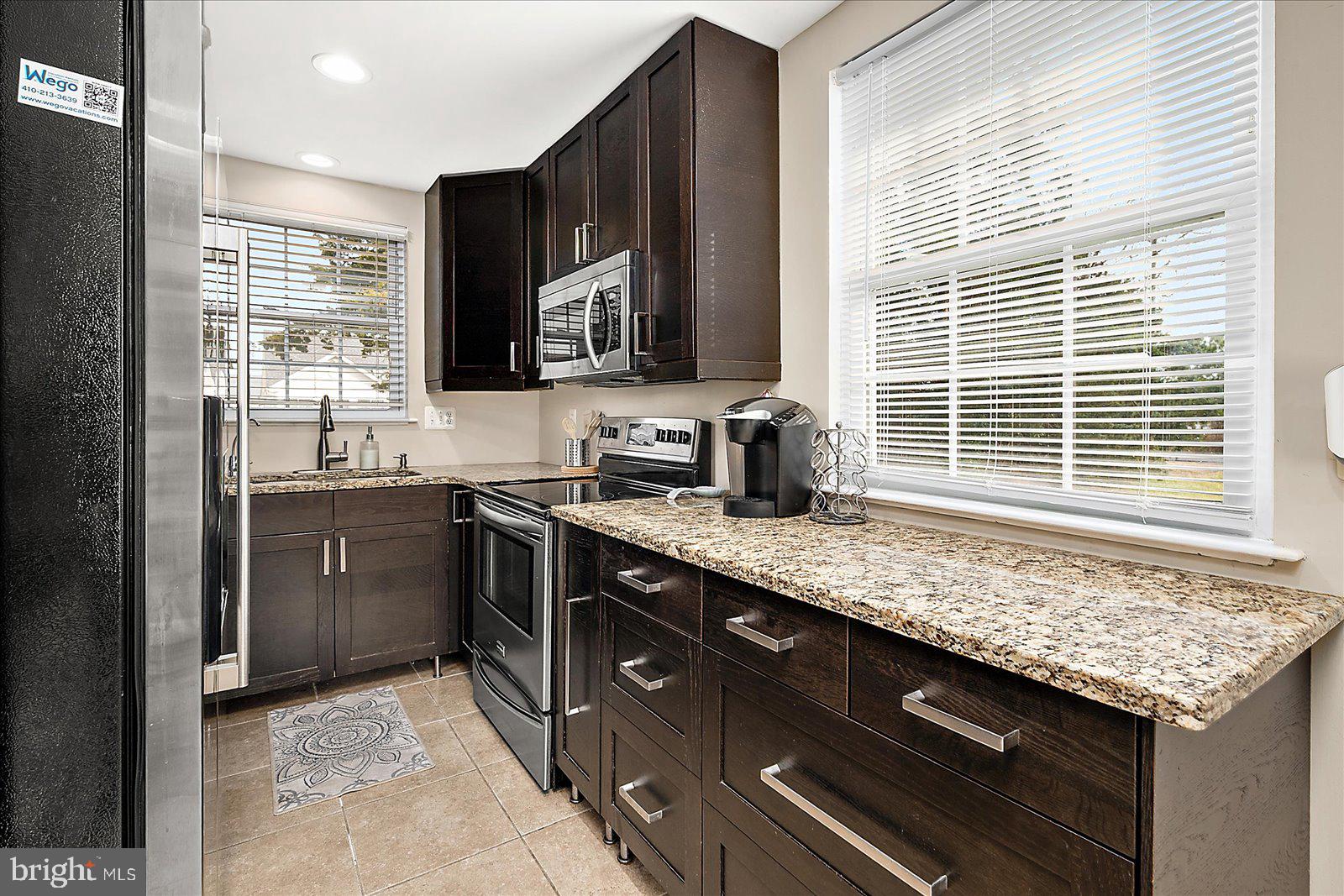 10428 Exeter Road Ocean City, MD 21842 - Photo 19 of 56 a kitchen with a sink stove and cabinets