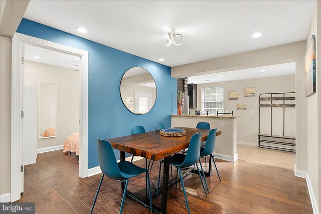 a large bed sitting in a bedroom and a chandelier