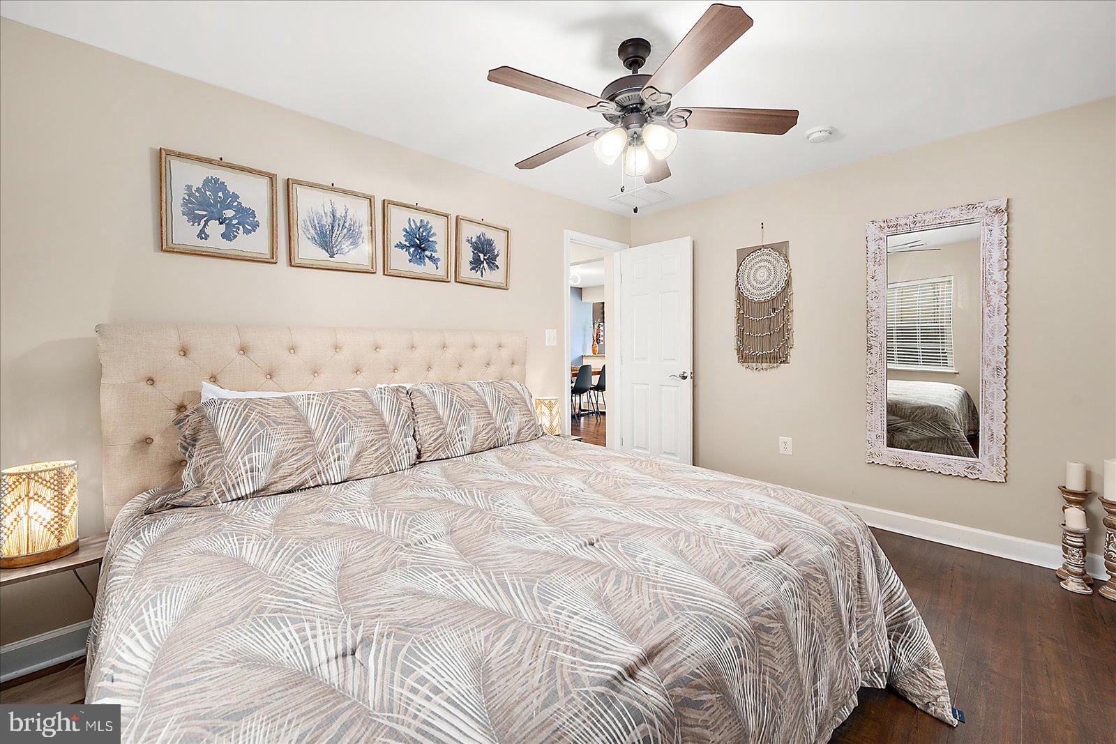 10428 Exeter Road Ocean City, MD 21842 - Photo 24 of 56 a large bed sitting in a bedroom and a chandelier
