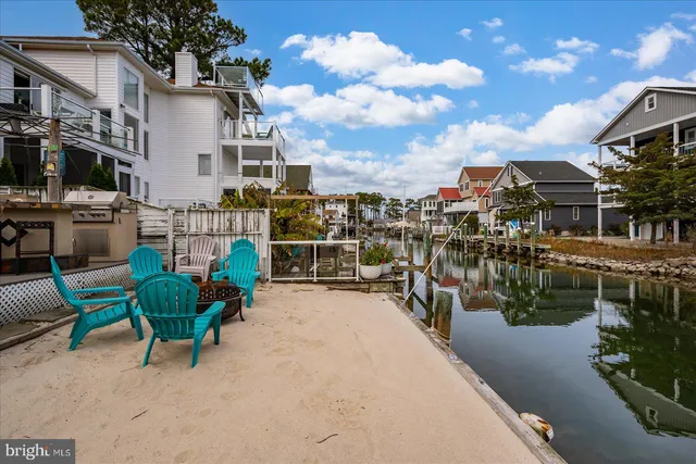 a view of a house with pool and a chairs