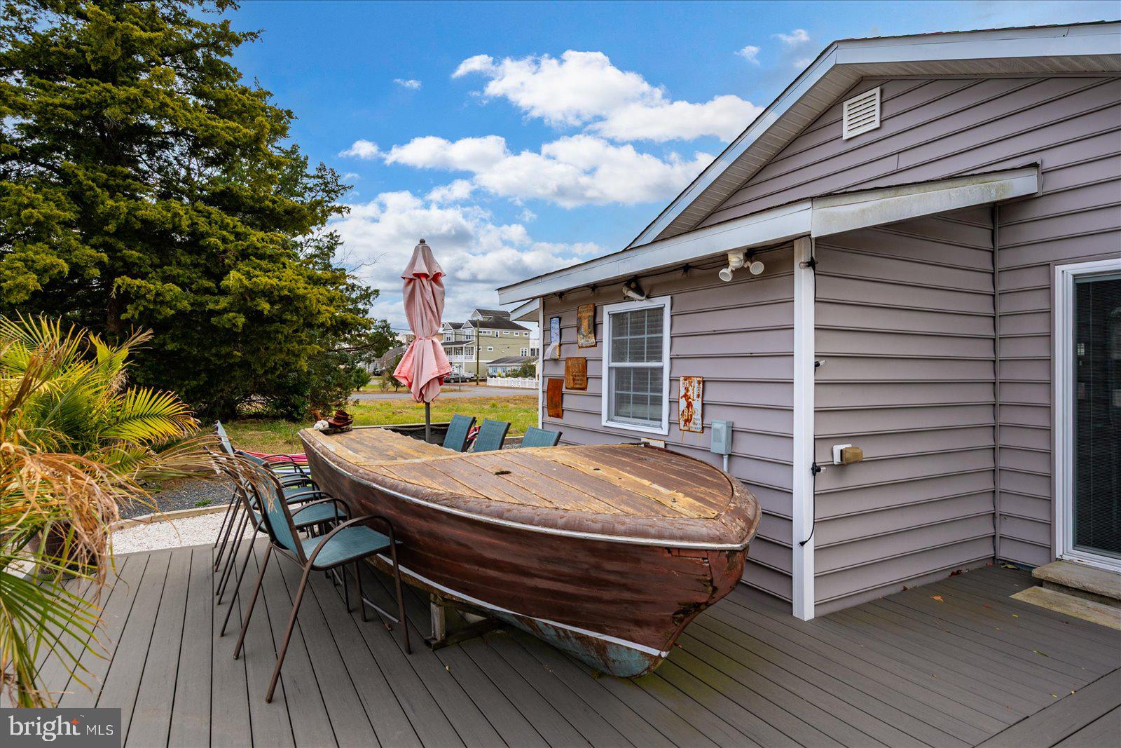 10428 Exeter Road Ocean City, MD 21842 - Photo 43 of 56 a view of a patio with table and chairs with wooden floor and fence