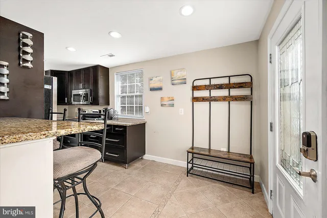 a view of a dining room with furniture and a window