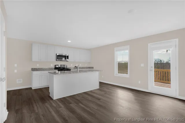 a kitchen with stainless steel appliances a refrigerator and a stove top oven