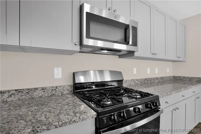 a stove top oven sitting inside of a kitchen