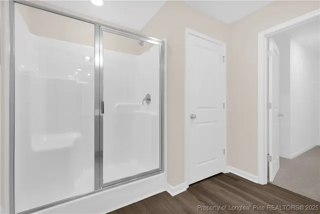 a bathroom with a glass shower door