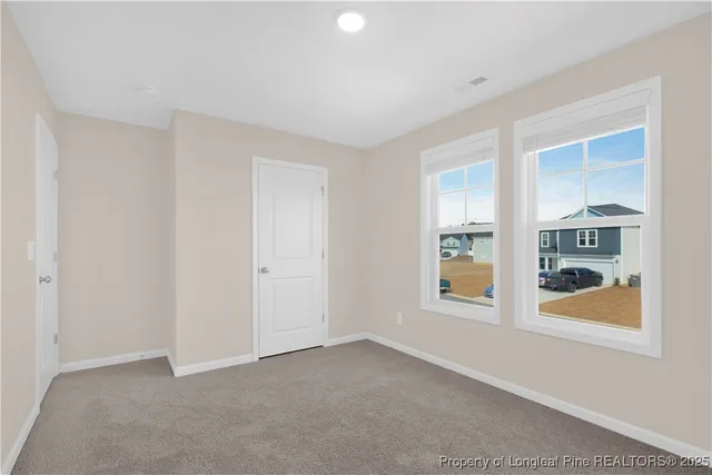 an empty room with windows and closet