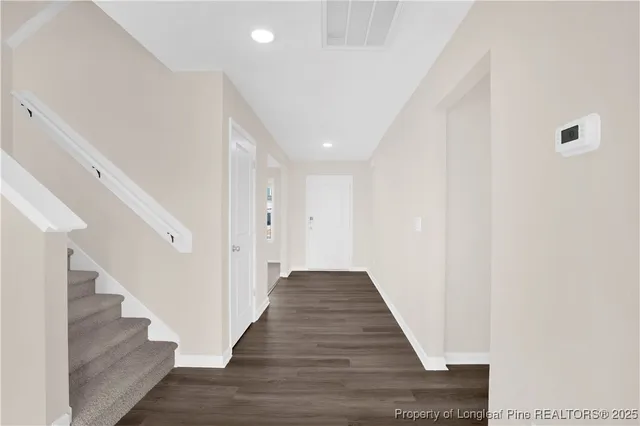 a view of a hallway with wooden floor