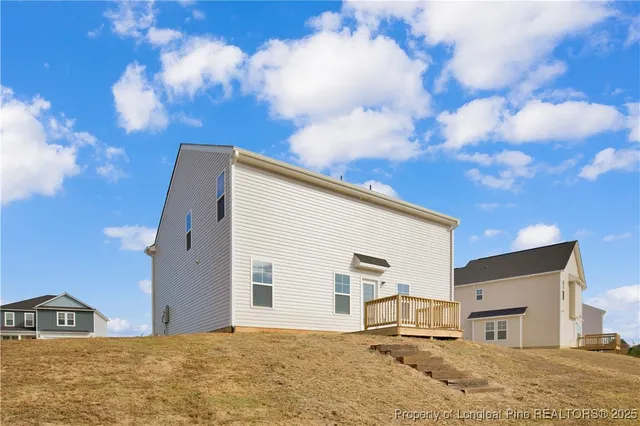 a view of a house with snow on the road