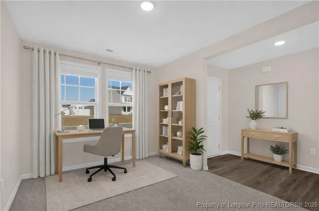 a view of a livingroom with furniture and a window