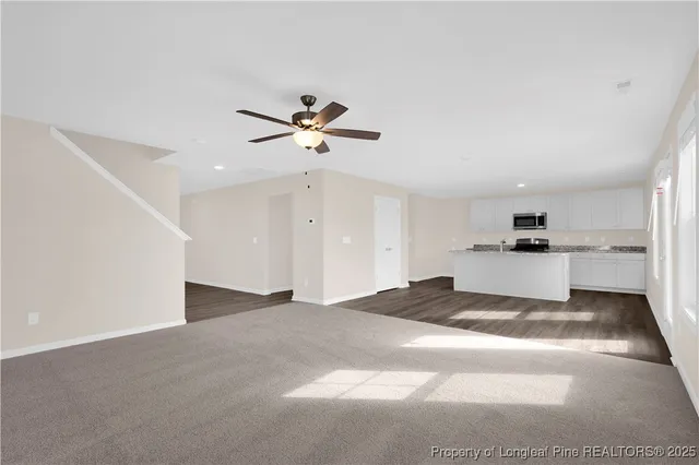 a view of a kitchen with a sink and refrigerator