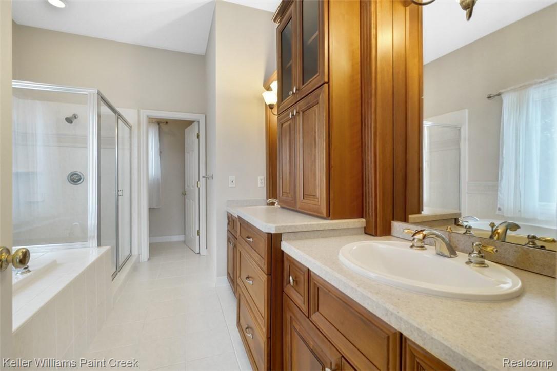 1400 Army Road Leonard, MI 48367 - Photo 29 of 56 Master Bath boasts two sink vanities, large walk in shower, soaking tub and tons of cabinet storage.