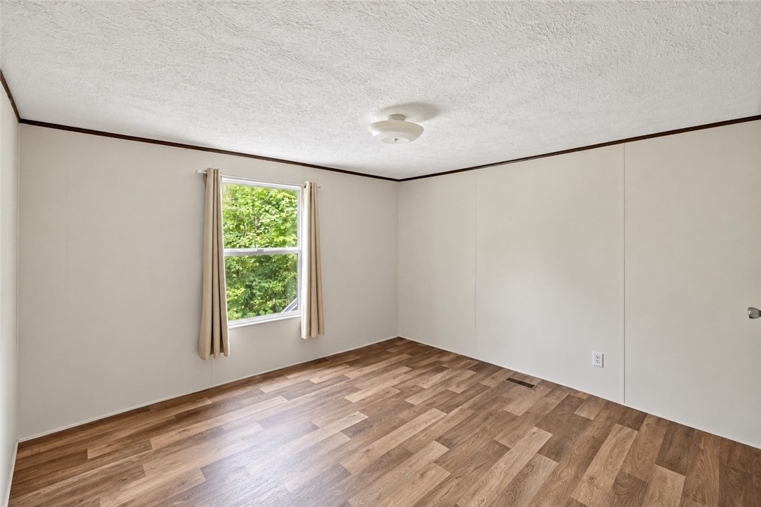 1309 Big Creek Road Belton, SC 29627 - Photo 16 of 21 Gleaming wood-look floors complement the clean lines and neutral walls of this versatile space.
