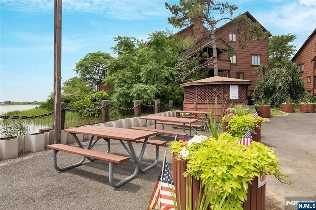 a view of a patio with table and chairs potted plants with wooden fence