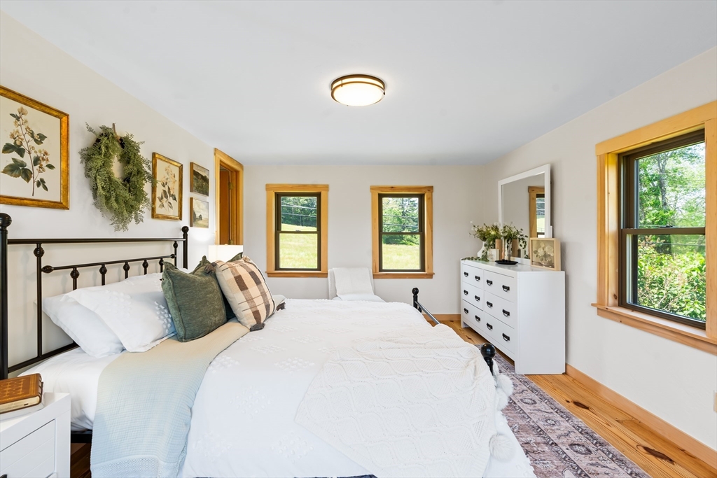 356 Hunt Road Oakham, MA 01068 - Photo 15 of 42 a bedroom with a bed and a window