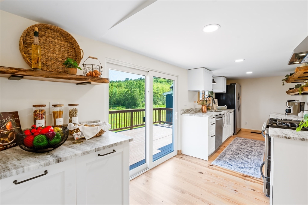 356 Hunt Road Oakham, MA 01068 - Photo 2 of 42 a kitchen with sink cabinets and outdoor view