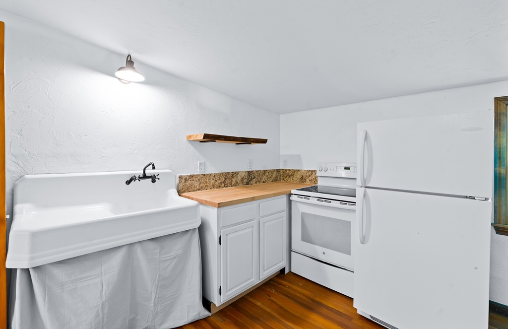 356 Hunt Road Oakham, MA 01068 - Photo 23 of 42 a kitchen with a sink and a refrigerator