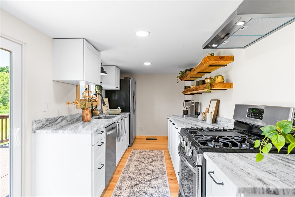 356 Hunt Road Oakham, MA 01068 - Photo 3 of 42 a kitchen with stainless steel appliances granite countertop a stove and a sink