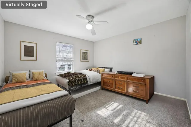 a bedroom with bed and window