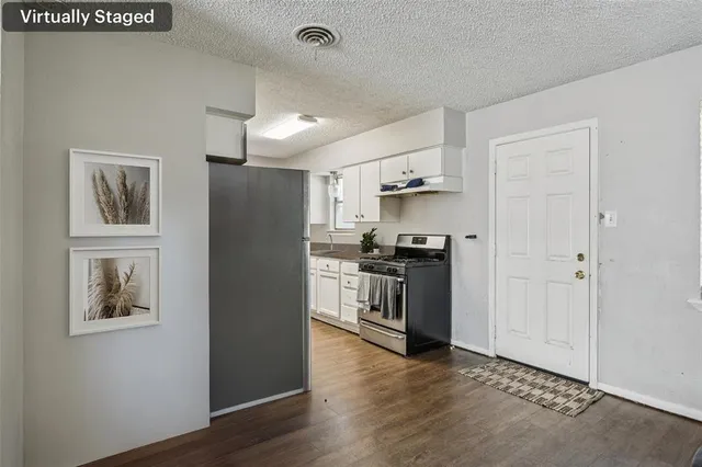 a kitchen with a refrigerator and a stove top oven