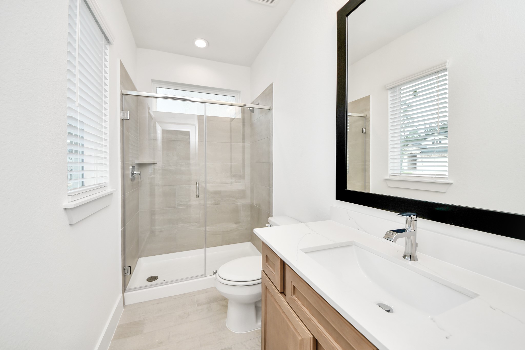 3102 Native Spg Drive Spring, TX 77373 - Photo 8 of 47 Secondary bath features tile flooring, walk-in shower with tile surround, light stained wood cabinets, beautiful light countertop.