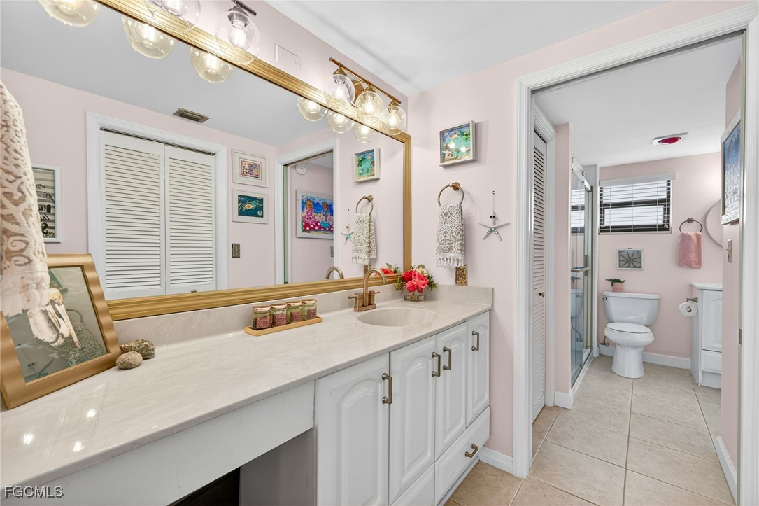 801 River Point Drive, Unit 203A Naples, FL 34102 - Photo 18 of 32 a bathroom with a sink double vanity and a toilet