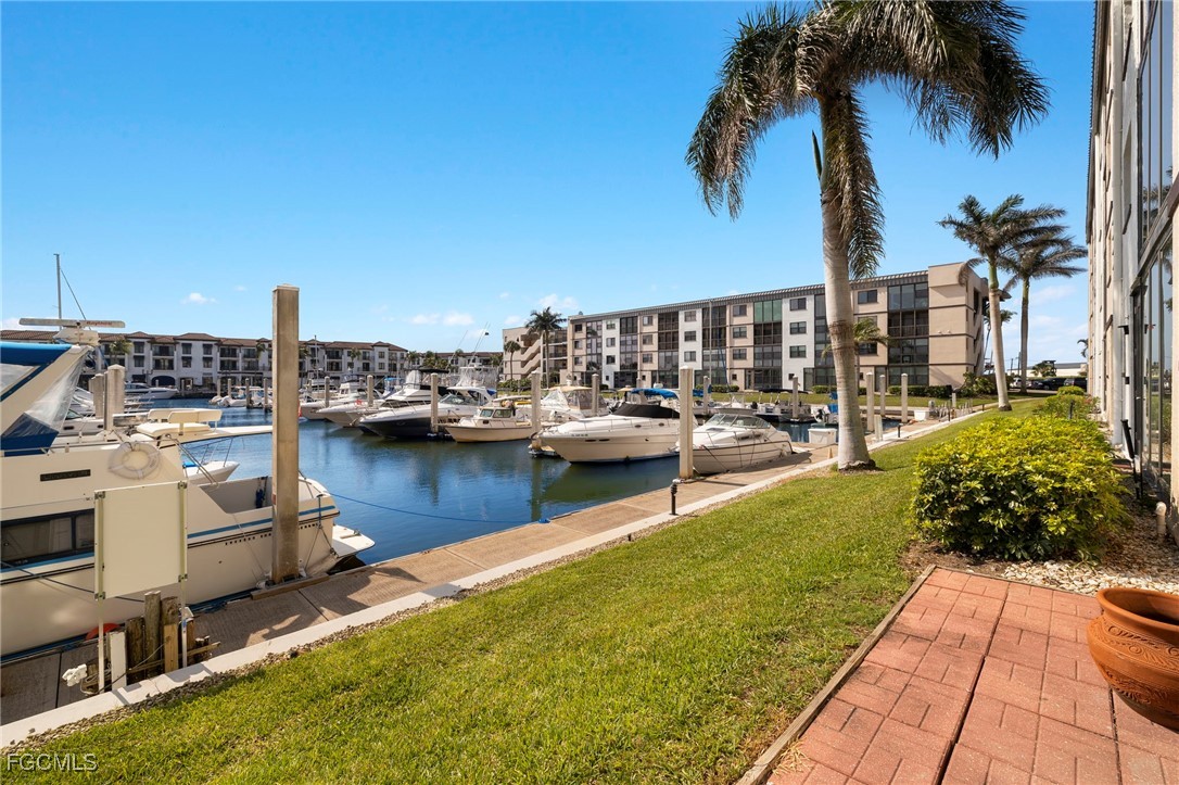 801 River Point Drive, Unit 203A Naples, FL 34102 - Photo 2 of 32 a view of a lake with boats and palm trees