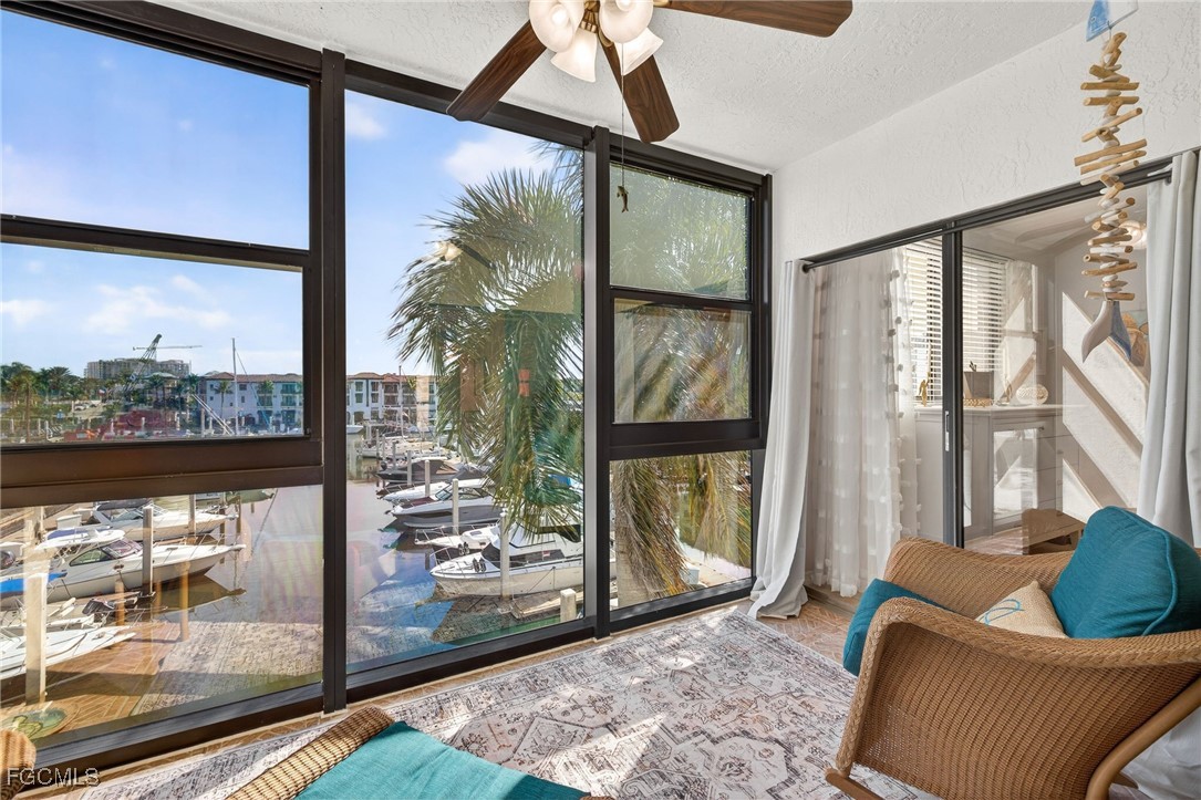 801 River Point Drive, Unit 203A Naples, FL 34102 - Photo 22 of 32 a living room with furniture and a floor to ceiling window