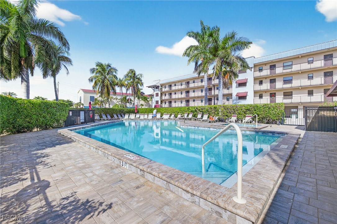 801 River Point Drive, Unit 203A Naples, FL 34102 - Photo 26 of 32 a view of a swimming pool with a garden