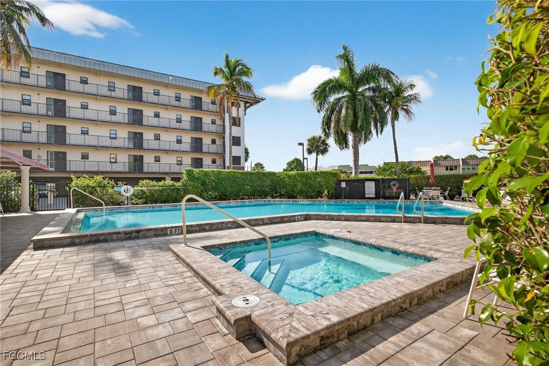 801 River Point Drive, Unit 203A Naples, FL 34102 - Photo 27 of 32 a view of swimming pool with a lounge chair