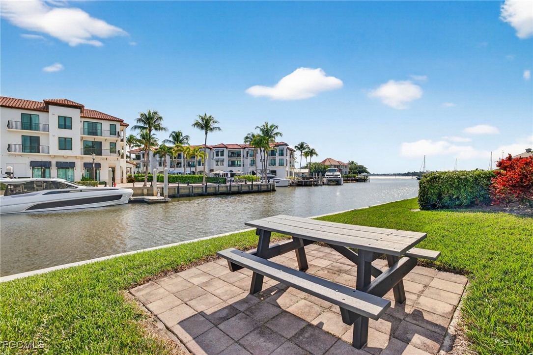 801 River Point Drive, Unit 203A Naples, FL 34102 - Photo 31 of 32 a view of a lake with couches chairs
