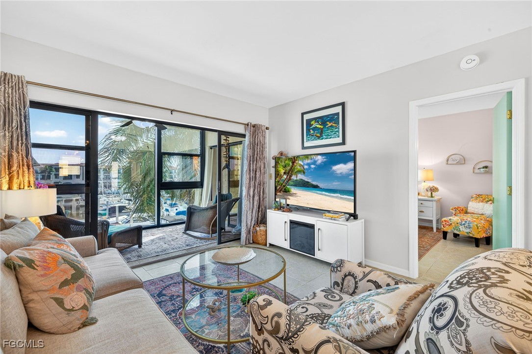 801 River Point Drive, Unit 203A Naples, FL 34102 - Photo 5 of 32 a living room with furniture and a large window