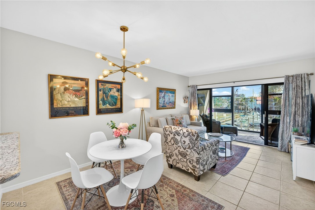 801 River Point Drive, Unit 203A Naples, FL 34102 - Photo 6 of 32 a living room with furniture and a large window
