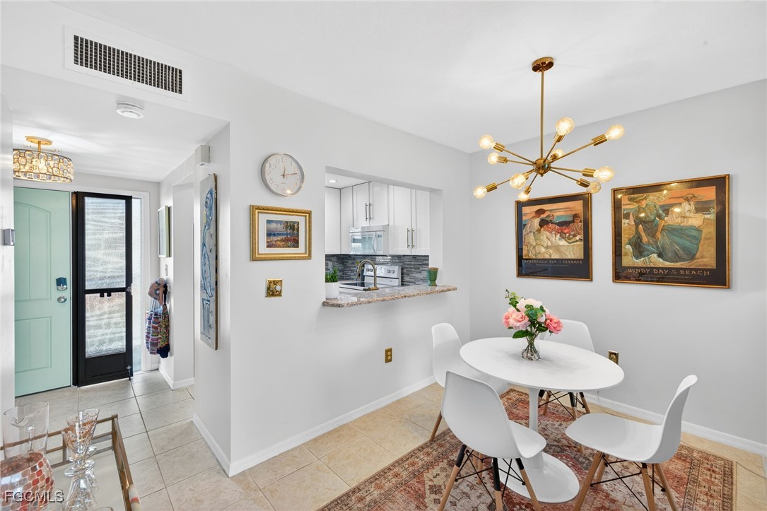 801 River Point Drive, Unit 203A Naples, FL 34102 - Photo 9 of 32 a view of a dining room with furniture